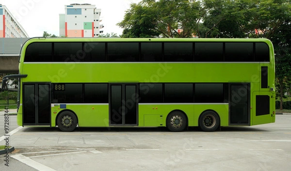 Fototapeta Blank double decker bus for advertising mock up wrap display. Out of home OOH advertising on public transportation. Green bus. No people