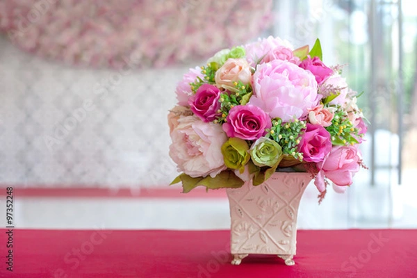Fototapeta colorful artificial flowers made from cloth in a rectangular ceramic vase on a table