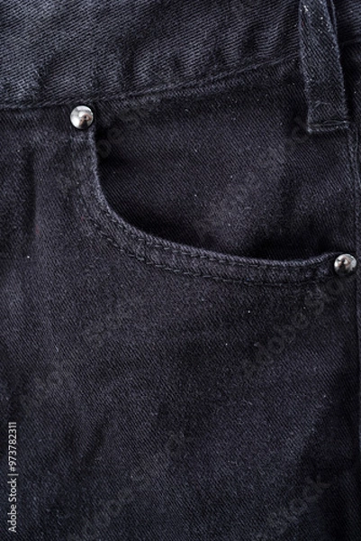Obraz Close-up of blue denim jean pocket on black leather jacket, detailed texture and stitching