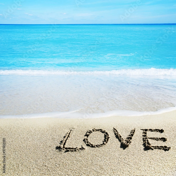 Fototapeta Love inscribed in the sand of a beach
