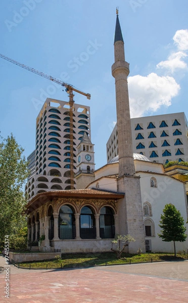 Fototapeta Ethem Bey Mosque in central Tirana, Albania. The Clock Tower and near-completed Book Building are behind. This Ottoman-Baroque mosque dates from early 1820s, the only surviving building from the Carsi