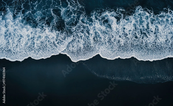 Obraz Aerial drone view or top view perspective photography of a beautiful transparent clear sea or ocean waves and foam splashing on the dark navvy blue or gray sand beach