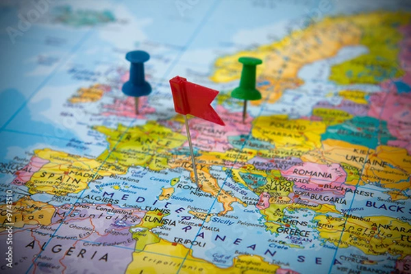 Fototapeta Three pins sticked in a map of Europe.
