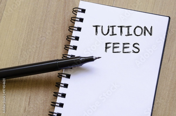 Fototapeta Tuition fees write on notebook