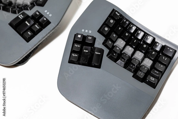 Fototapeta Ergonomic grey black split keyboard mechanic on an isolated background