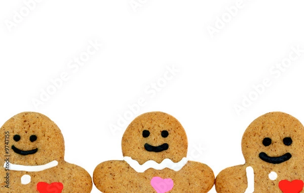 Obraz Gingerbread cookie faces bottom border on white