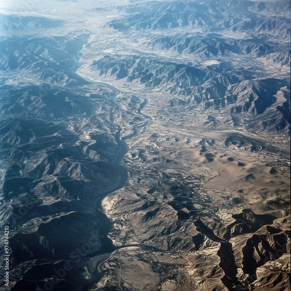 Fototapeta Terrain – Bird’s-Eye View of Diverse Terrain Featuring Mountains, Rivers, and Arid Land