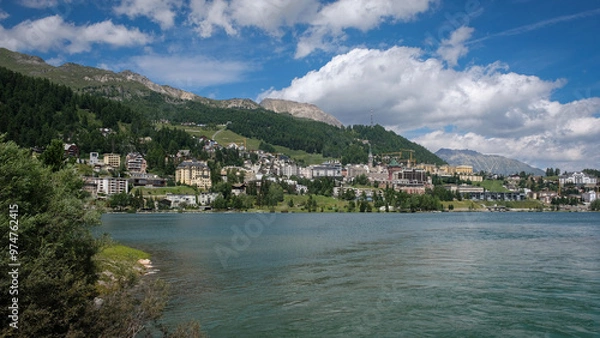 Fototapeta The mountain lake of St. Moritz with the fashionable alpine resort in the background on a nice summer day