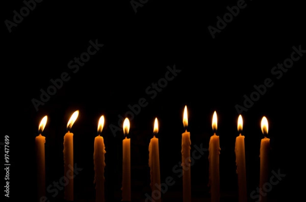 Obraz frame light candle burning brightly in the black background