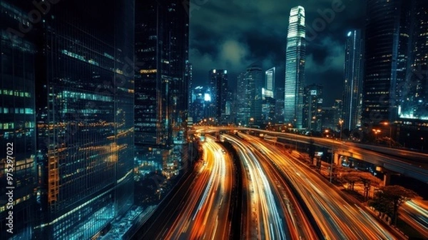 Fototapeta Nighttime cityscape with illuminated skyscrapers and traffic trails.