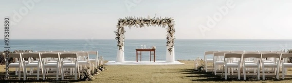 Fototapeta Oceanside Wedding Ceremony A White Floral Arch Frames the Vow Exchange with Rows of White Chairs Facing the Horizon