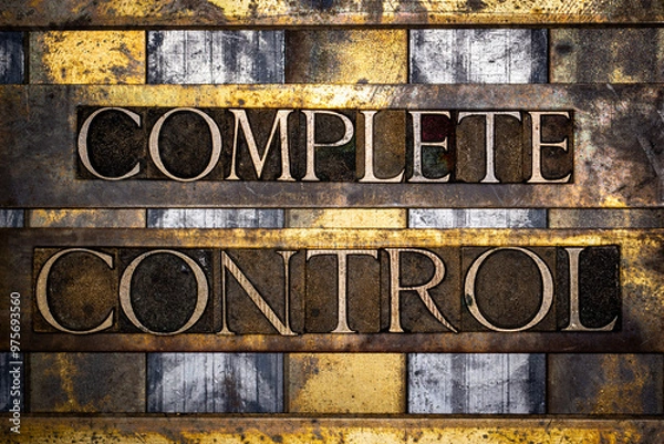 Fototapeta Complete Control text in real authentic typeset letters on vintage textured silver grunge copper and gold background