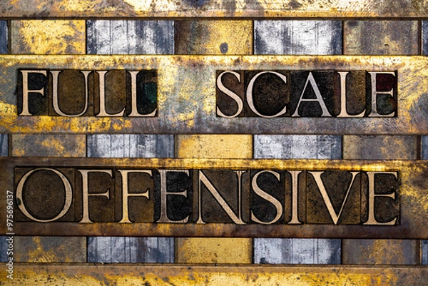 Fototapeta Full Scale Offensive text in real authentic typeset letters on vintage textured silver grunge copper and gold background