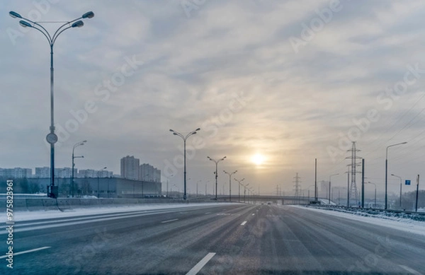 Fototapeta On the morning of the first of January, there are few cars on the highway
