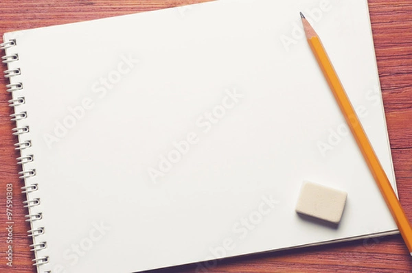 Obraz Blank opened notepad with pencil and eraser on brown wooden table vintage filtered