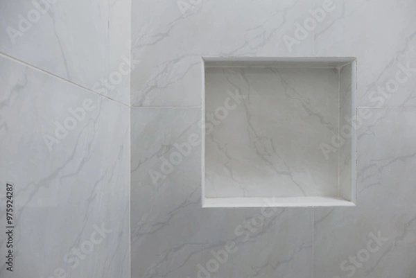 Fototapeta Close up of empty built-in shower caddy in wall recess in bathroom. Modern elegant bathroom interior with marble wall tiles. Display shelf for toiletries logo branding mockup