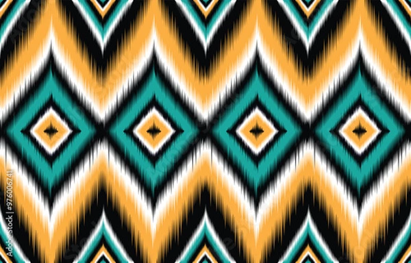 Fototapeta Teal and orange ikat pattern. Chevron geometric seamless design. Ethnic tribal motif. Vibrant bohemian textile print. Abstract wallpaper background. Modern trendy fashion fabric. Ikat repeat texture.