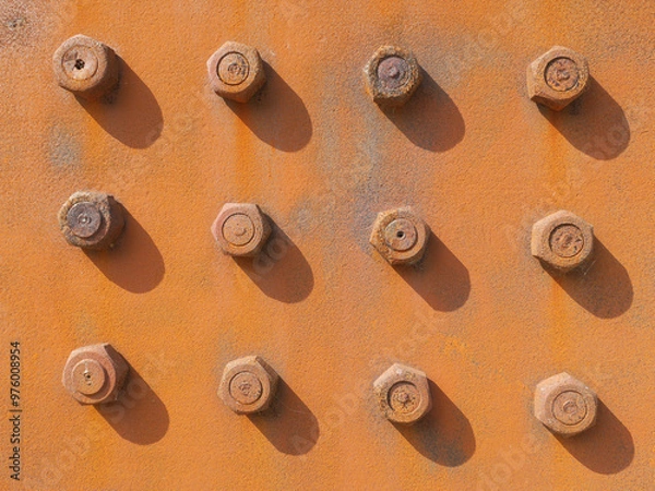 Fototapeta rusty nuts and bolts on a rusty steel plate