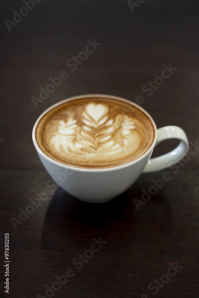 Fototapeta Close-up latte art coffee on wood table (Selective focus)