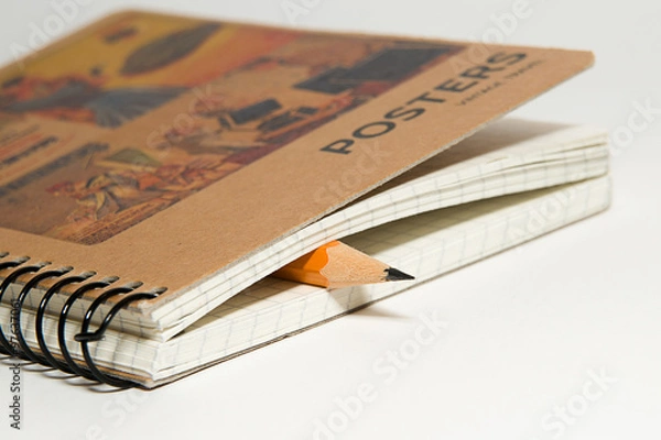 Obraz Closed notebook  and pencil on over white