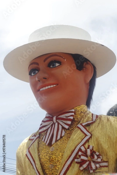 Obraz A giant puppet of a man adorned with a hat and a shimmering gold jacket at the Olinda Brazilian Carnival.