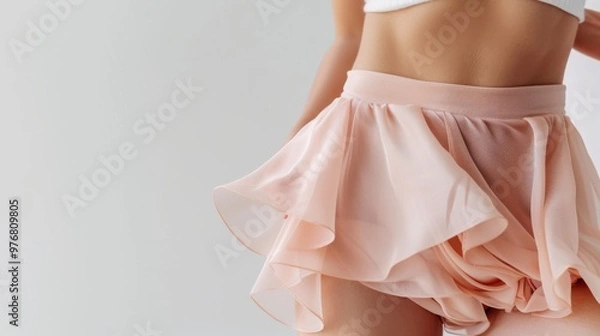 Fototapeta Intimate cosmetic and weight-loss concept, with a focus on a woman’s perfect hips and abdomen, elegantly covered in chiffon, against a bright white background.
