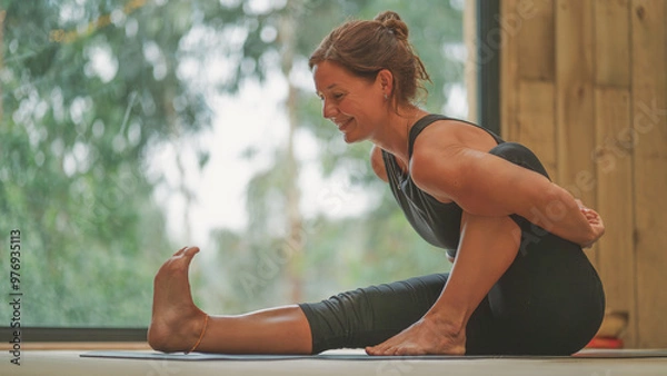 Obraz Smiling Woman show Vinyasa yoga pose close to a window 