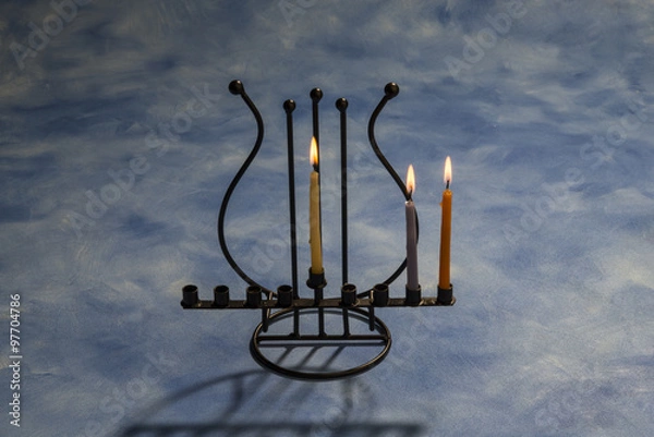 Obraz Two burning Hanukkah candles in Menorah