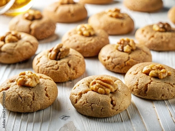 Fototapeta Fresh walnut cookies from Greece on a studio-white surface, awaiting a sweet syrup infusion