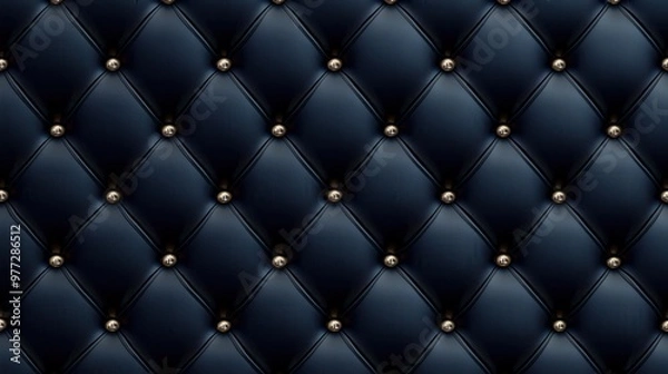 Fototapeta A black and gold patterned leather surface with gold studs. The surface is smooth and shiny