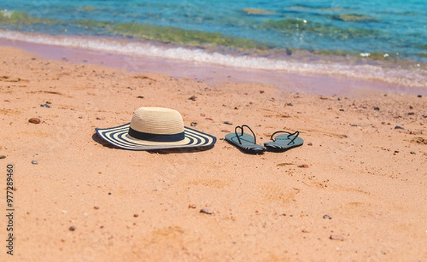 Fototapeta Hat and beach flip-flops. Selective focus.