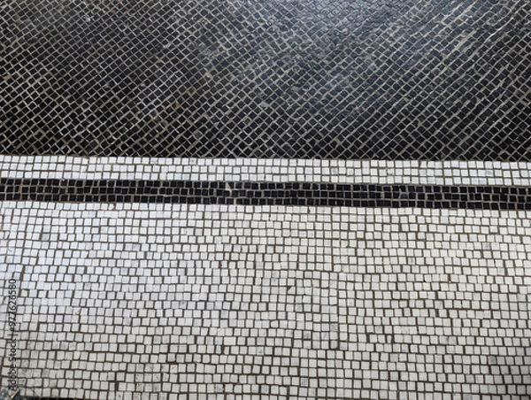 Fototapeta black and white tiling with stone and intense dark grout on the floor of a fancy rich space