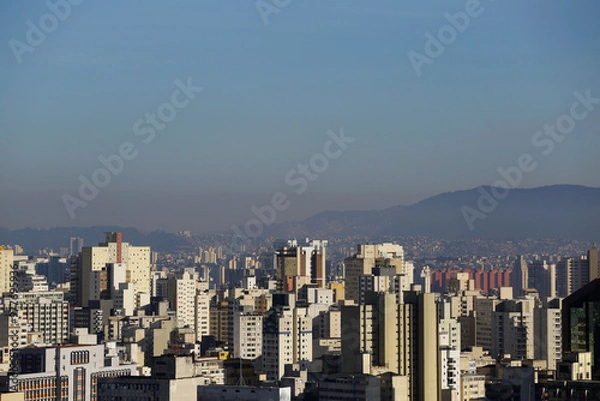 Fototapeta A thick layer of air pollution is seen covering the city of Sao Paulo, Brazil. Pico do Jaragua mountain is seen in the background right.