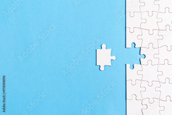 Fototapeta Completing the last piece of puzzle