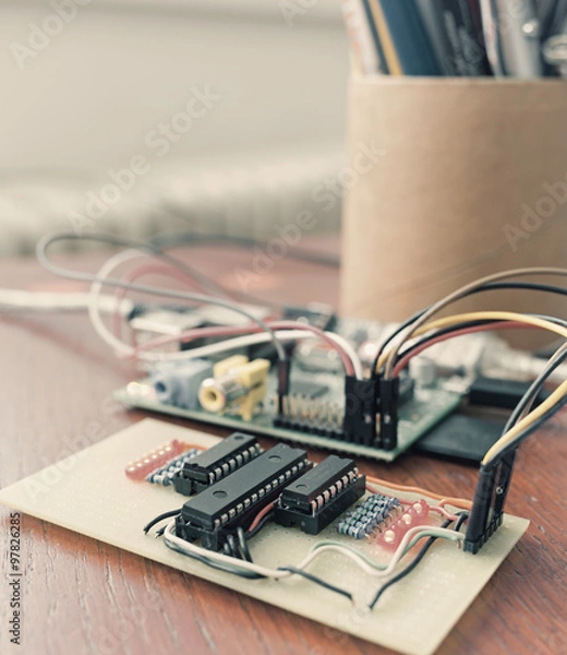 Obraz Vintage style photo of tabletop experiment with Raspberry Pi and home-brewed circuit with some of the LED on. Filters applied for vintage effect.
