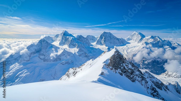 Fototapeta A breathtaking view of Switzerland showcasing majestic snow-covered mountains under a clear blue sky, creating a serene and picturesque landscape.