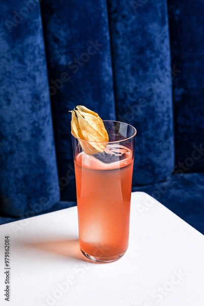 Obraz An alcoholic cocktail in a highball collins glass garnished with physalis served with ice