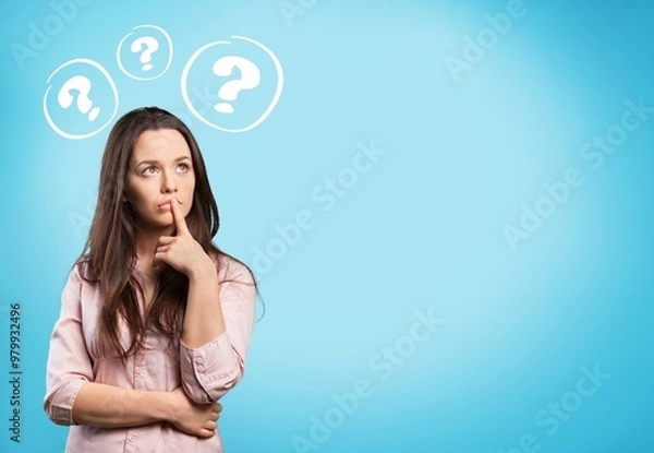 Fototapeta Worried young sad woman with a question mark