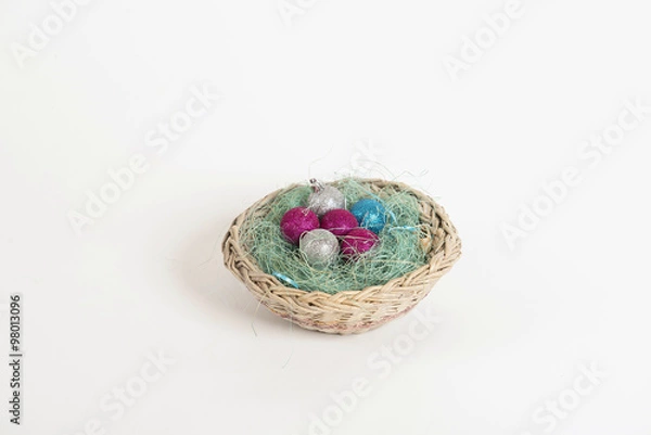Fototapeta Christmas balls lying in a basket in the nest