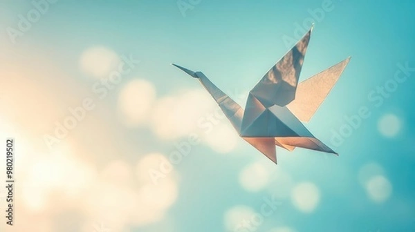 Obraz A lowangle shot of an origami crane suspended in midair by invisible strings