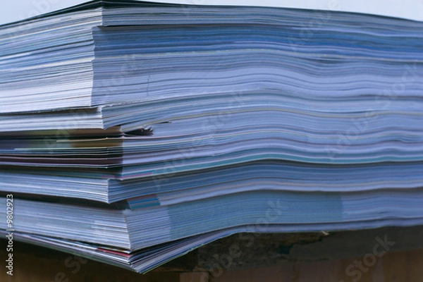 Fototapeta Stack of magazines laying on office table