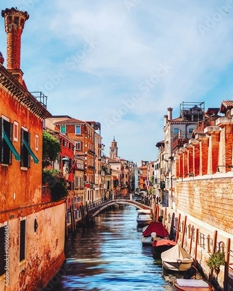 Fototapeta Venetian canal view featuring Ponte de Ca' Bala with gondolas, bordered by colorful historic buildings and the Leaning Santo Stefano Tower, a prominent medieval structure in the city.