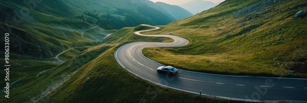 Fototapeta Aerial view of car and winding road in high mountain pass. Serpentine curvy road