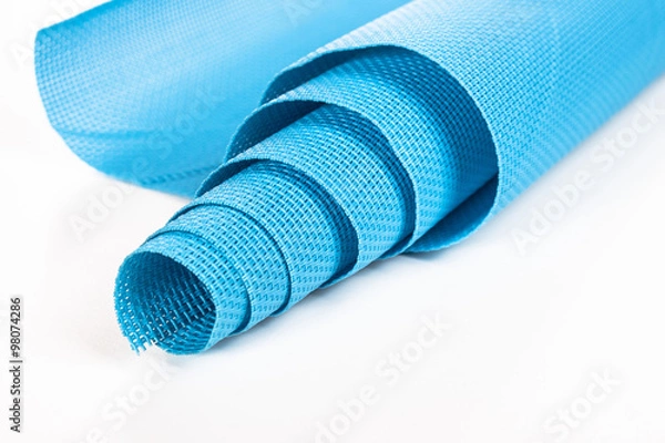 Obraz rolled blue napkin on a white background