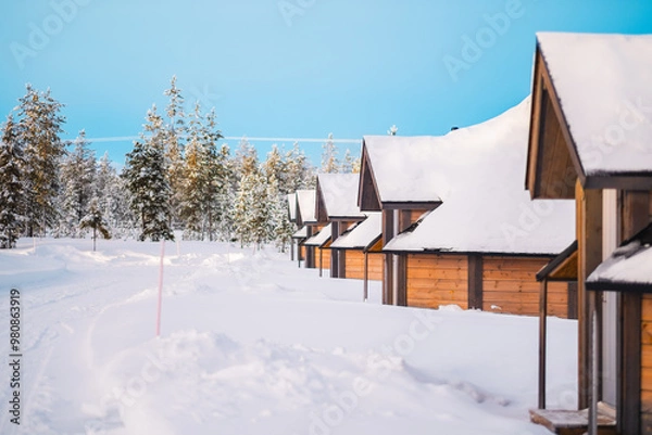 Obraz Wooden Igloos Standing in a Row in the Snow
