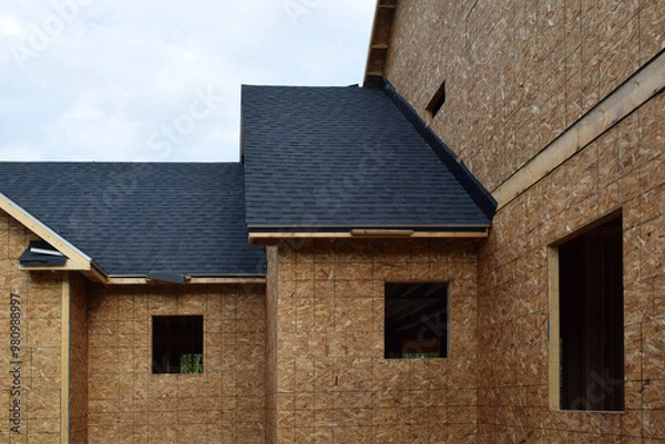 Fototapeta New Home Under Construction with Lumber Framing and Carpentry Builders Craftsman