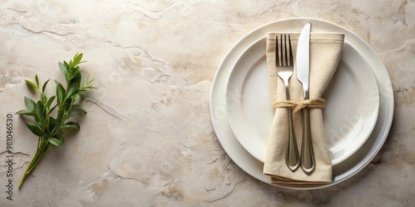 Fototapeta "Elegant table setting featuring a white craft plate, cutlery, and napkin on a white stone table, with a beige napkin and cutlery arranged artistically, providing ample copy space."