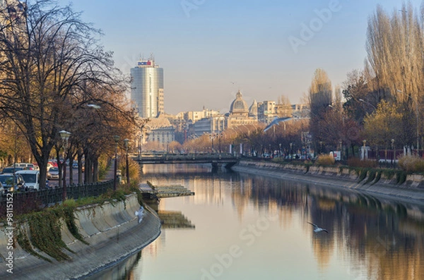 Fototapeta Cityscape from Bucharest with Dambovita River in sunset light
