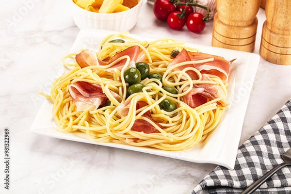 Fototapeta Pasta spaghetti with olives and jamon