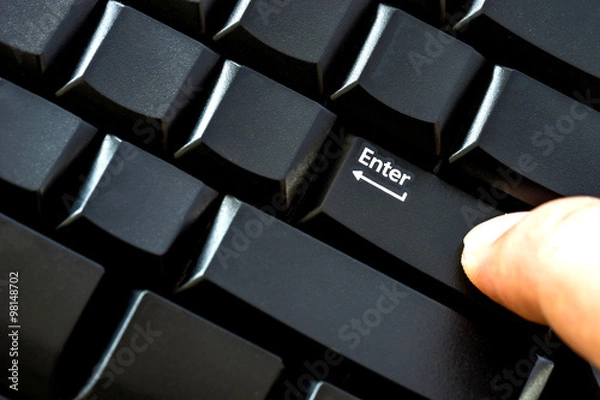 Obraz Finger pressing enter key close up